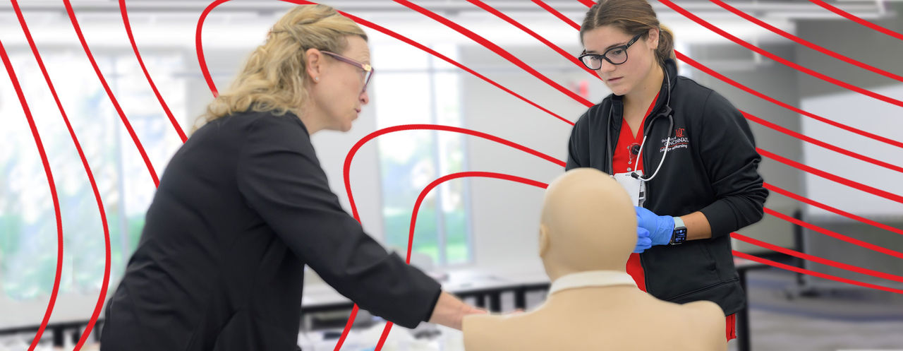 instructor and student practicing with manikin