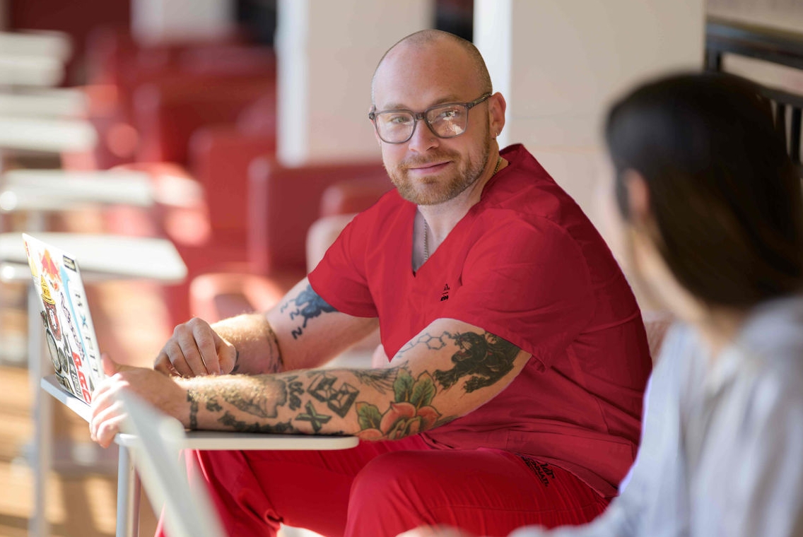 student wearing red scrubs