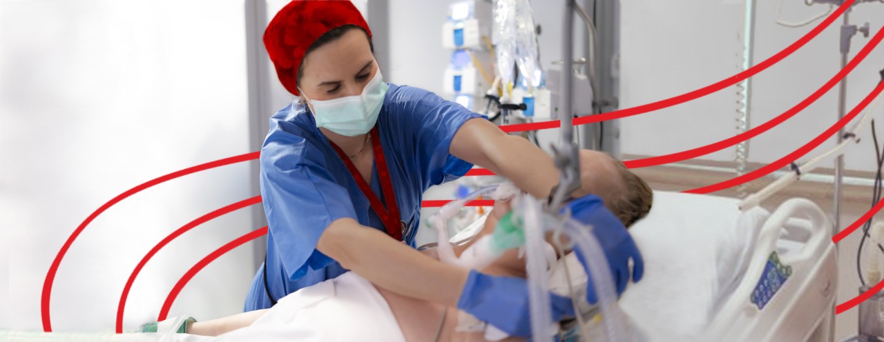 nurse adjusting equipment for patient in the ICU